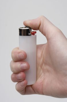 Women hand holding a white lighter