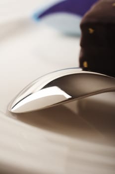 Spoon on the plate with chocolate cake