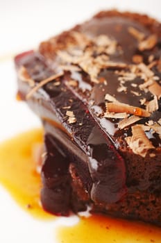 Close-up of a chocolate cake with red jelly and coffee syrap