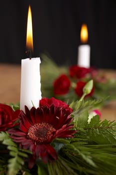 Candles with flower setup on the brown table
