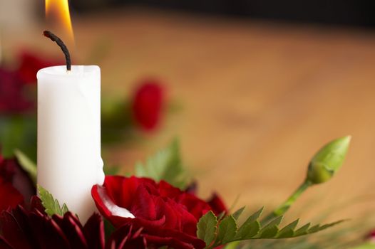 Candles with flower setup on the brown table