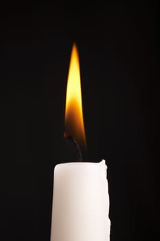 Isolated candle stick with light over a black background