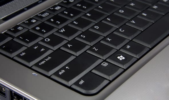 Silver laptop black keybord closeup