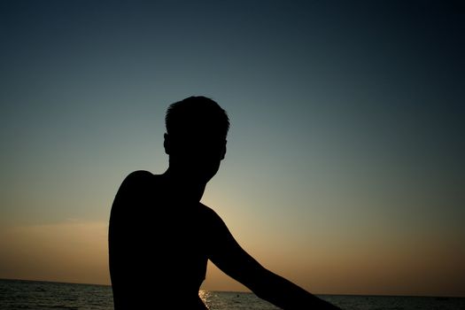 Adult man on the evening beach