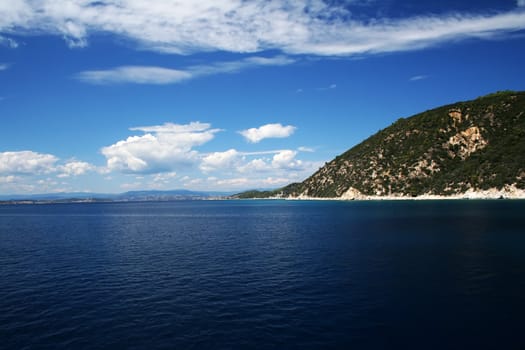 Tropical sea shore, blue sky and dark blue sea