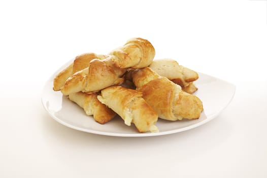 Pile of cheese filled pastry rolls over a white background