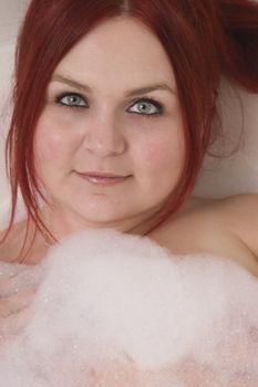 Close up of a red hair model in bubble bath