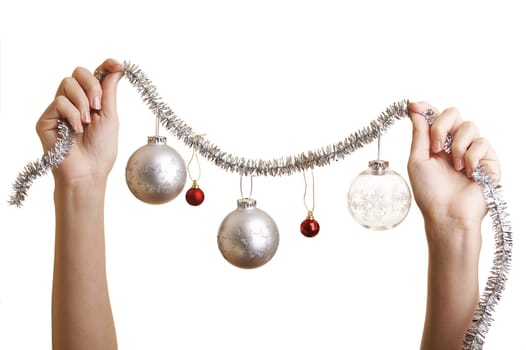 Woman about to hang a Christmas ornaments 