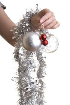 Woman about to hang a Christmas ornaments