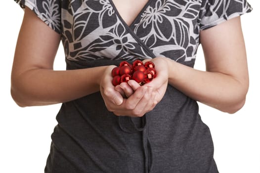 Girl with handful of christmas ornaments (red christmas balls).