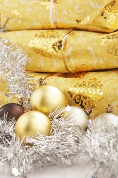 Christmas present on the table with golden and silver balls