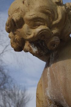 Rear view of a cherubin statue with blue sky background