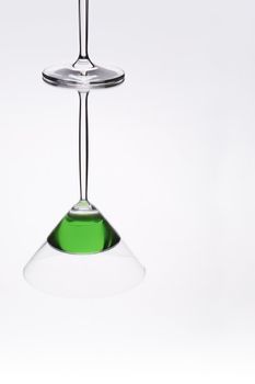 Cocktail glass reflection on shiny mirror like surface