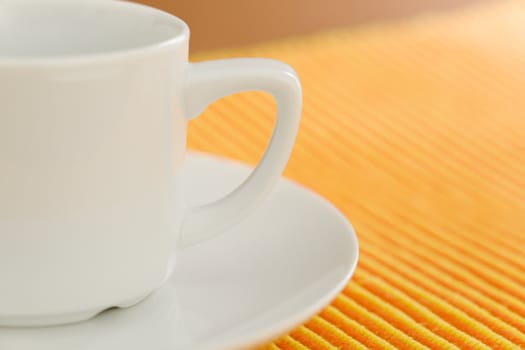 Empty coffee on orange - yellow striped fabric