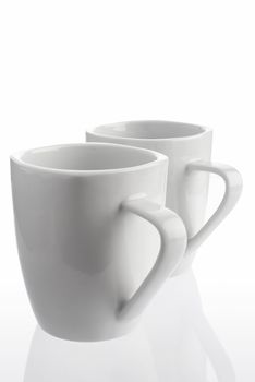 Pair of white coffee cups on white background