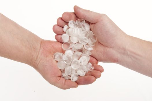 Pellucid stones in hands on white background- tender relationships.