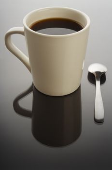 Coffee cup on black background with spoon