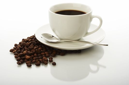 White coffee cup with coffee beans