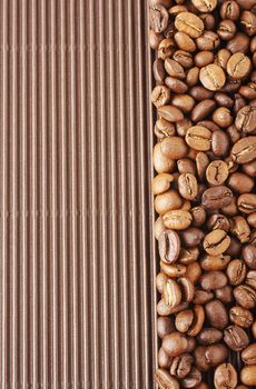 Lined coffee beans on the brown cardboard