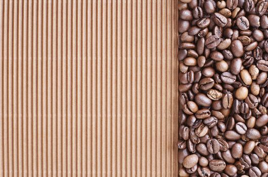 Coffee beans over a brown curly cardboard 