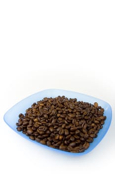 Blue plastic plate filled with coffee beans