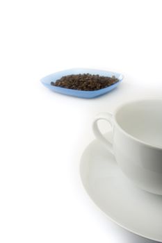 White empty coffee cup with plate full of beans