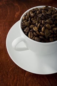 Coffee cup filled with brown beans
