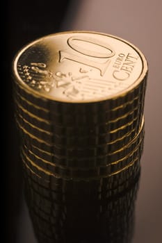 10 euro cent coins stacked on black table