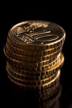 10 euro cent coins stacked on black table