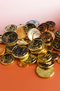 Stack of euro coins on the red table