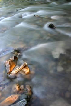 Mountain stream with light of sunset on the rocks