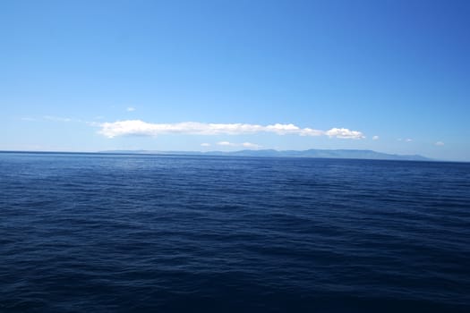 Perfect Blue Sea with coast on horizon