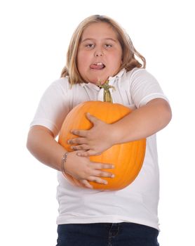 A young girl holding a heavy and large pumpkin, isolated against a white background