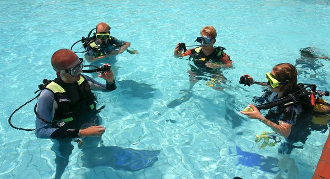 Instructor and students during scuba diving lessons