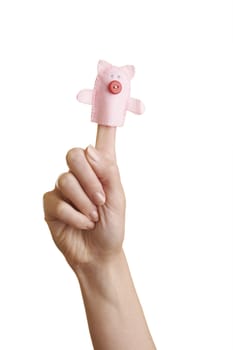 Isolated girl's hand with finger puppet (farm animal: pig)