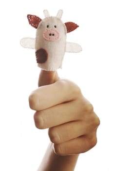 Girl's hand with animal finger puppet (cow)