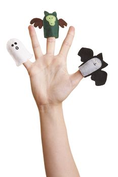 Girl's hand with halloween finger puppets (ghost, bat and dragon)