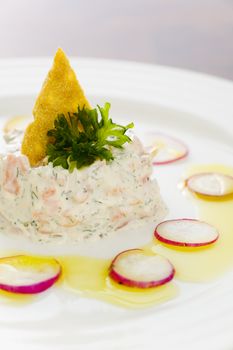 Creamy salmon mousse with vegetables on the plate