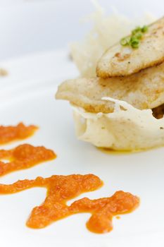White fish on the cheese basket with pepper dressing (shallow dof)