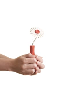 Girl handing a wooden flower over a white background