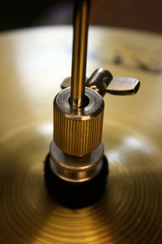detail focus on the top of a set of brass drum kit symbols.