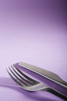 Fork and spoon on the purple table