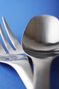 close up of spoon and fork on the blue table