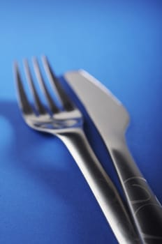 Fork and knife on the blue table