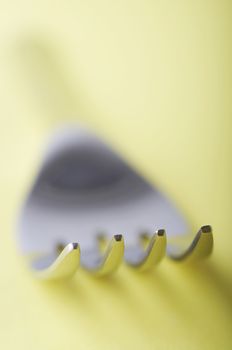 Close up of fork with shallow dof on the yellow table