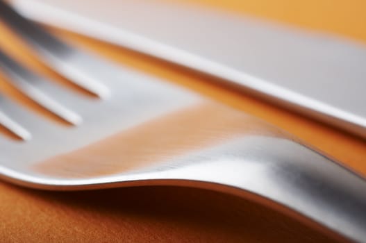 Close up of fork with shallow dof on the orange table