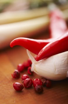 Thai food spices on wooden board (pepper, chili, garlic and lemon grass)