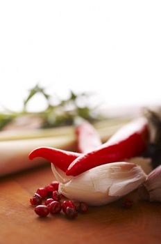 Thai food spices on wooden board (pepper, chili, garlic and lemon grass)