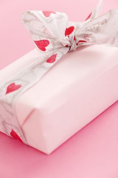 Pink gift box over a pink background