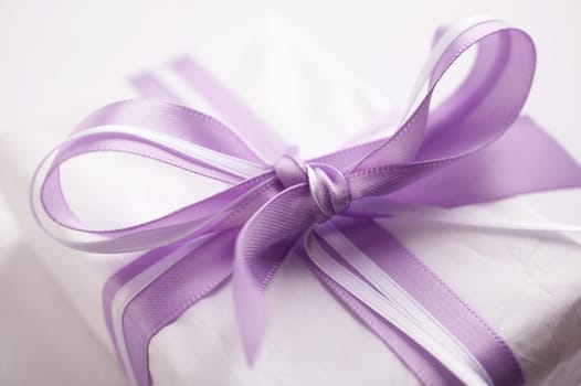 Close up (macro) of a small gift box over a white background